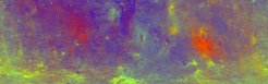 The false-color map shows that Vesta's north (top) and south (bottom) are completely different. While the northern hemisphere is predominantly colored in blue, the southern hemisphere shows extensive yellowish-greenish areas.