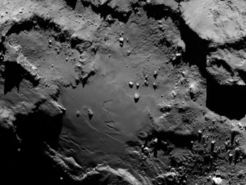 Stunning close up detail focusing on a smooth region on the ‘base’ of the ‘body’ section of comet 67P/Churyumov-Gerasimenko. The image was taken by Rosetta’s OSIRIS narrow-angle camera and downloaded today, 6 August. The image clearly shows a range of features, including boulders, craters and steep cliffs.
The image was taken from a distance of 130 km and the image resolution is 2.4 metres per pixel.