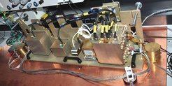 The EFM with its stacked Electronics Unit (large metal box) including the power converter, various control units and the digital processing unit as well as two of the mechanism simulators and two image sensor units on the front side as well as the camera power supply visible on its back side.