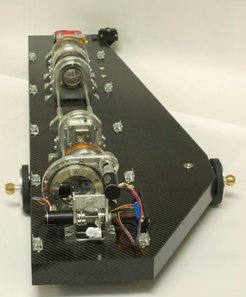 The wave-front sensor, mounted on its light-weightcarbon fiber sandwich plate. Two fixation points are visible on the sides.