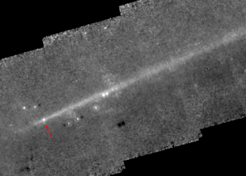 The debris trail of comet 67P. This image was obtained with the Spitzer Space Telescope when 67P was near its aphelion in April 2006. The arrow marks the position of the comet nucleus, while all other point sources are incompletely removed background objects or asteroids. The debris trail consists of mm-sized and larger particles remaining close to the comet for many orbital periods due to their low sensitivity to solar radiation pressure (Agarwal et al., 2010).
