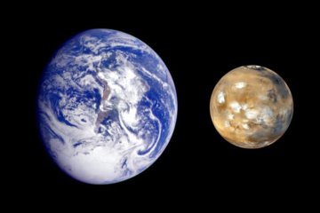 Images of earth and Mars side by side: a mostly blue sphere with a pale reddish landmass in the center mostly, hidden by while swirling clouds, on the left, three-quarter-illuminated, and a smaller, fully-illuminated reddish-brown sphere with some white patches on the visible surface on the right. Image credit: NASA/JPL