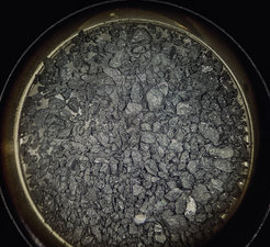 Microscopic image of rock material from the asteroid Ryugu. The black grains are only a few millimeters in size.
